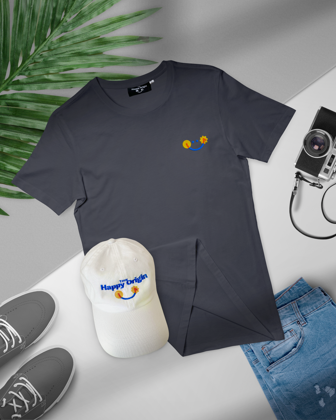 The Happy Origin premium happy tee flat lay